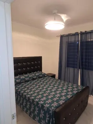 a bedroom with a bed in a room with a window at Residencial cayena del este Santo Domingo este in La Grúa