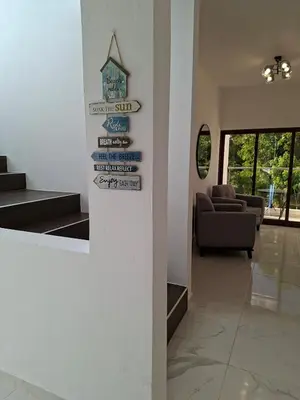 a lobby with stairs and a sign on a wall at Hermosa villa familiar cucu's home beach in Río San Juan
