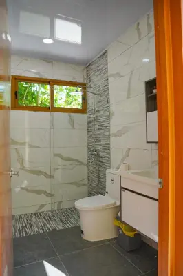 a bathroom with a toilet and a sink and a shower at Villa my place in Bonao