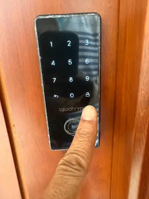 a person pressing a button on a elevator door at Luxury Oceanfront Condo in Sosúa