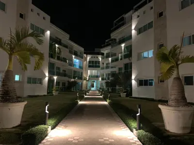 a walkway in front of a building at night at Luxury Oceanfront Condo in Sosúa