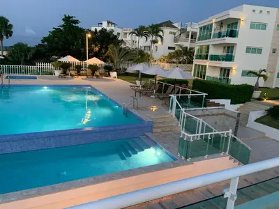 a large swimming pool in front of a building at Luxury Oceanfront Condo in Sosúa