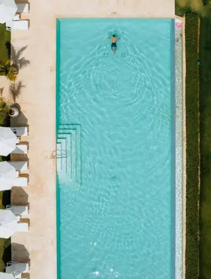 an overhead view of a person swimming in a swimming pool at Playa Bonita Modern Beachfront Penthouse - 3BR in Las Terrenas
