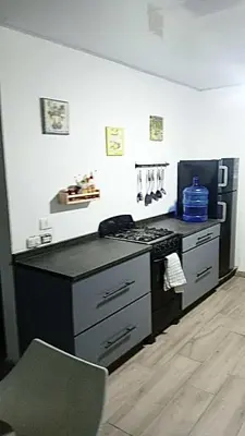 a kitchen with a stove and a refrigerator at Casa Valentina in Río San Juan