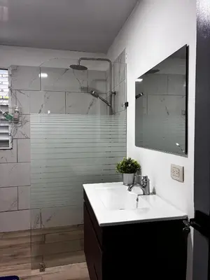 a bathroom with a sink and a shower with a mirror at Casa Valentina in Río San Juan