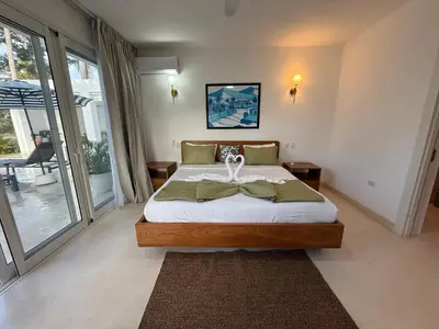a bedroom with a large bed and a large window at Charming Villa GUGI #80 in Palmeras de Coson, Las Terrenas in Las Terrenas