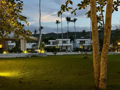a park with palm trees and buildings at night at Charming Villa GUGI #80 in Palmeras de Coson, Las Terrenas in Las Terrenas