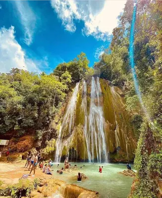 a group of people in the water at a waterfall at Guest-House Caracol 1- 2 Pax, vista al mar in Las Galeras