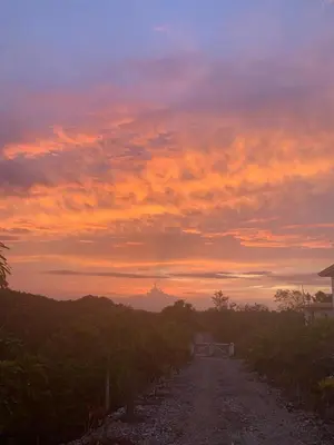 a dirt road with a sunset in the background at Villa Brisa del Caribe in Las Terrenas