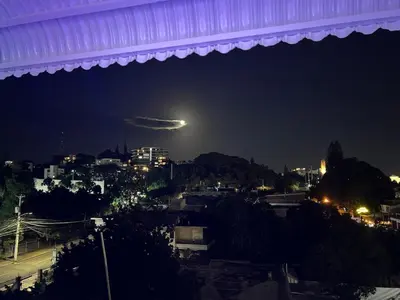 a view of a city at night with a moon at Style and comfort in downtown Santiago in Santiago de los Caballeros