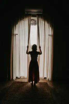 a woman is standing in front of a window at OYA New Earth Private Jungle Cabin with Individual Campfire in Jamao al Norte