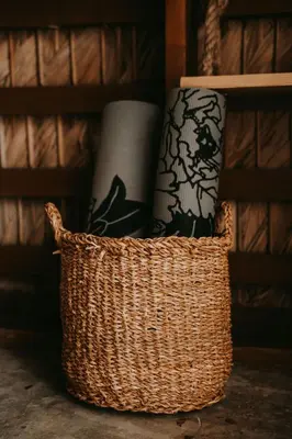 a wicker basket with two toilets in a shelf at OYA New Earth Private Jungle Cabin with Individual Campfire in Jamao al Norte