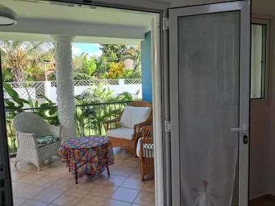 an open door to a patio with a chair and a table at Apartamentos Cayuco 28 in La Laguna