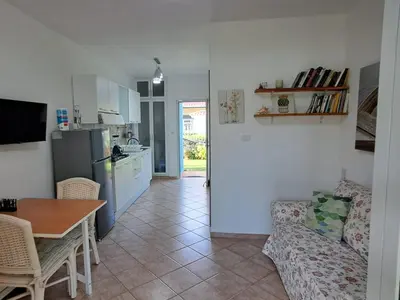 a kitchen and living room with a table and a couch at Apartamentos Cayuco 28 in La Laguna