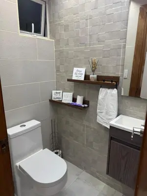a bathroom with a toilet and a sink at Chic City Apartment Walk to Everything! in Santo Domingo