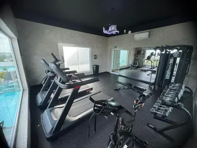 a gym with several treadmills and exercise bikes at Chic City Apartment Walk to Everything! in Santo Domingo