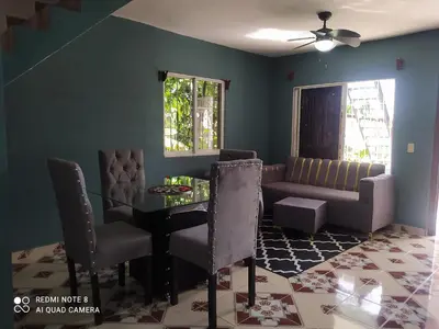 a living room with a table and a couch at Recidencia Don Carlos
