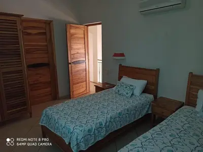 a hotel room with two beds and a window at Beachfront apartment in Las Terrenas