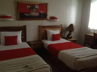 a bedroom with two beds with red pillows at Beachfront apartment in Las Terrenas