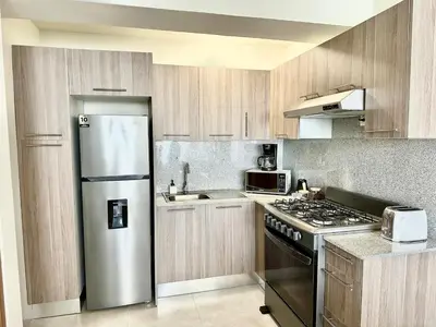 a kitchen with a stainless steel refrigerator and a stove at Paradises Room in Boca Chica