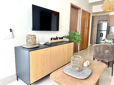 a living room with a tv on top of a cabinet at Paradises Room in Boca Chica