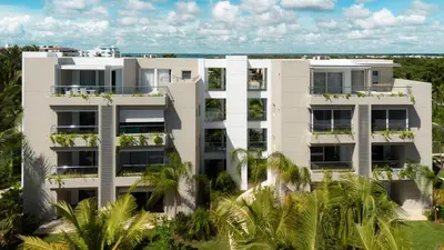 an aerial view of a white apartment building with palm trees at TRACADERO Ocean Pearl Suite in La Laguna