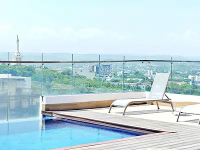 a white chair sitting on the edge of a swimming pool at Suite Panorama in Colorado