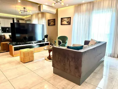a living room with a couch and a flat screen tv at Con Estilo Soha II in Colorado