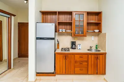 a kitchen with a white refrigerator and a sink at Agualina Kite Hotel in Cabarete