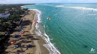 an aerial view of a beach with people flying kites at Agualina Kite Hotel in Cabarete