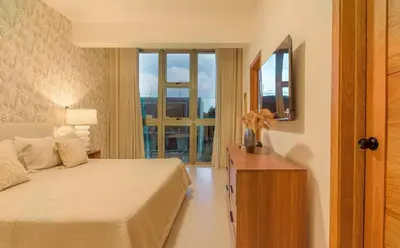 a hotel room with a bed and a window at Villa Privada + Piscina | Playa & Golf in Punta Cana