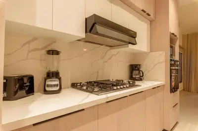 a kitchen with a stove and a blender at Villa Privada + Piscina | Playa & Golf in Punta Cana