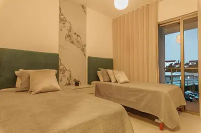 two beds in a hotel room with a window at Villa Privada + Piscina | Playa & Golf in Punta Cana