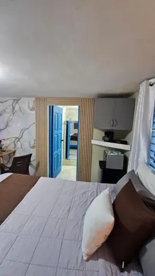 a bedroom with a large bed with a blue door at Nido de amor in Jarabacoa