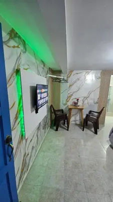 a room with a wall with a tv and a table at Nido de amor in Jarabacoa
