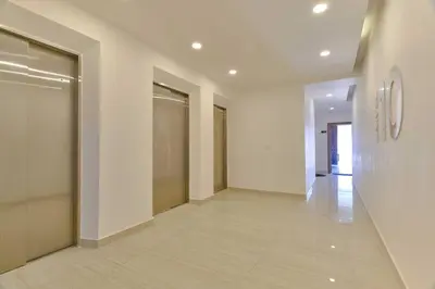 a hallway of a building with a door and a hallwayngth at Lovely 3 Bedroom Apartment, Pool,Gym,2parking S in Santo Domingo