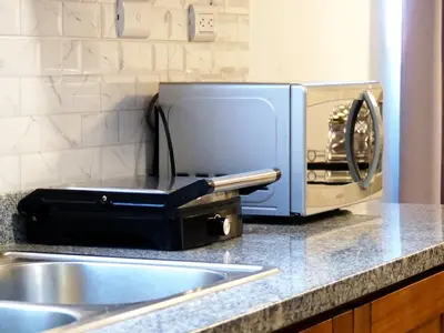 a kitchen counter with a toaster and a microwave at Aparta Plus 4th Nivel in Colorado