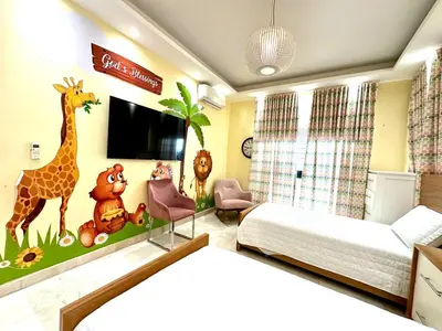 a bedroom with a giraffe and other animals on the wall at Villa Olga Premium in Colorado