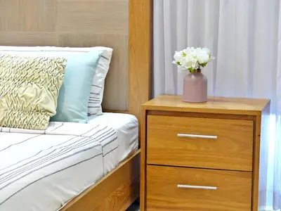 a bed with a dresser with a vase of flowers on it at Villa Olga Premium in Colorado