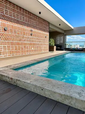a swimming pool in front of a brick building at Master Suite Rialto Residences in Colorado