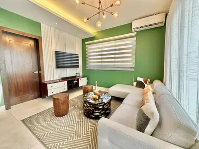 a living room with a couch and a tv at Master Suite Rialto Residences in Colorado