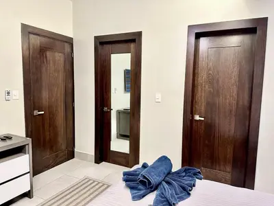 a bedroom with two doors and a blue towel on a bed at Master Suite Rialto Residences in Colorado