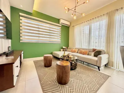 a living room with green walls and a couch and two logs at Master Suite Rialto Residences in Colorado