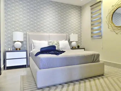 a bedroom with a bed and two night stands with lamps at Master Suite Rialto Residences in Colorado