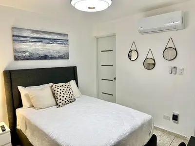 a bedroom with a bed and a painting on the wall at Mini Hogar 2 in Colorado