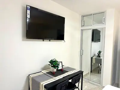 a flat screen tv hanging on a wall in a room at Mini Hogar 2 in Colorado