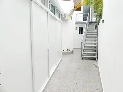 a hallway of a white house with a staircase at Mini Hogar 2 in Colorado