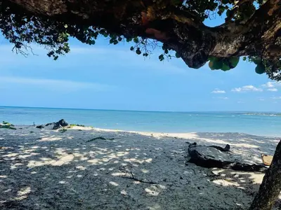 a sandy beach with the ocean in the background at Marien Residences 305 Deluxe High Floor Condo in Puerto Plata