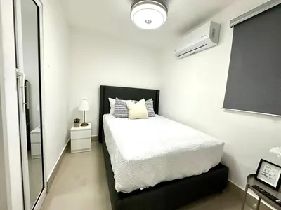 a bedroom with a bed with a black headboard at Mini Hogar 3 in Colorado