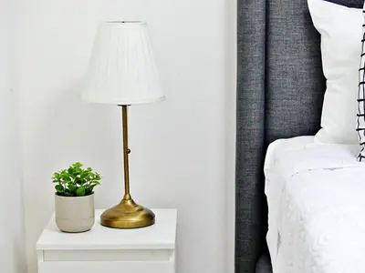 a lamp on a night stand next to a bed at Mini Hogar 3 in Colorado